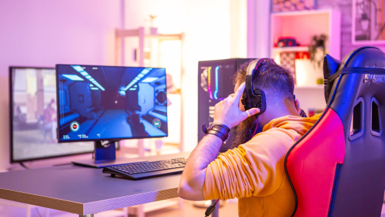 Bearded Man Playing Online Video Games On His Pc And Talking With Others Players Colorful Neons In The Room